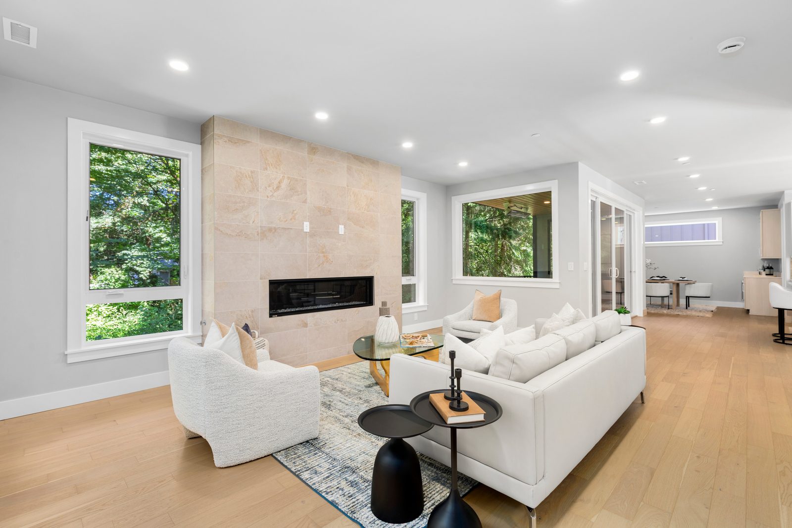 Open-concept great room with a sleek fireplace