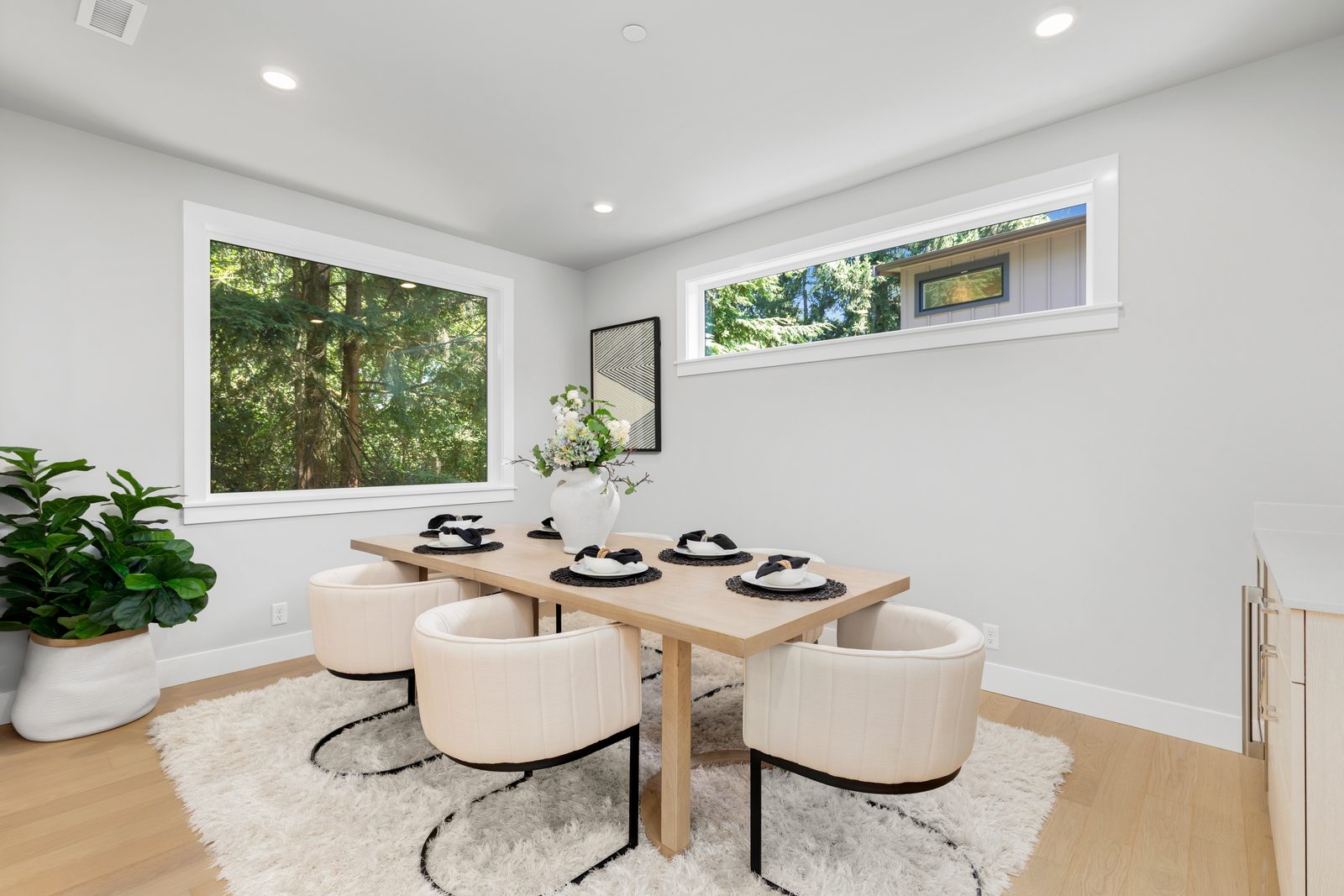 Elegant dining room surrounded by large windows