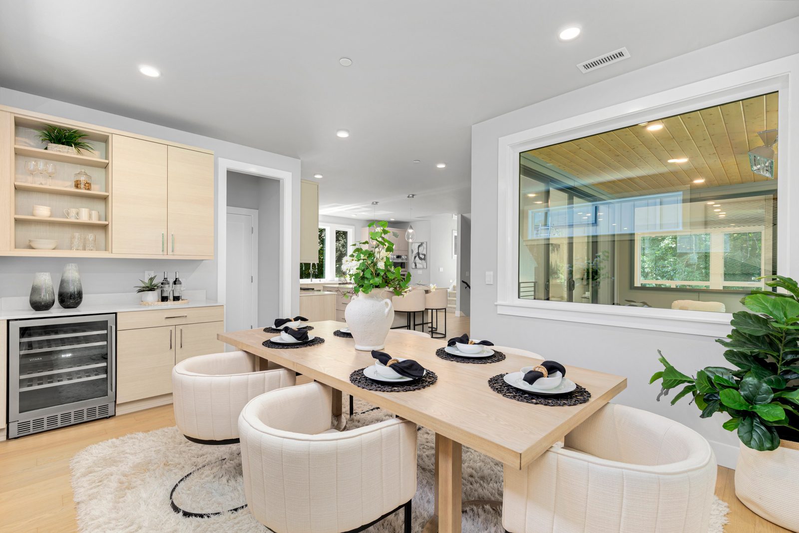 Inviting dining space with built-in beverage station and wine refrigerator.