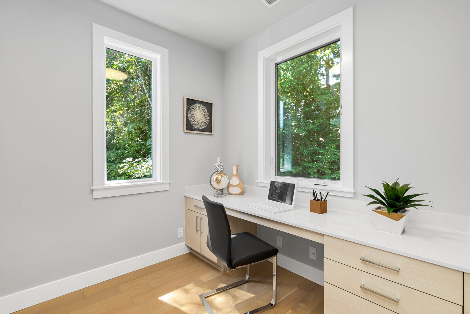 Private home office with built-in desk and serene woodland views.