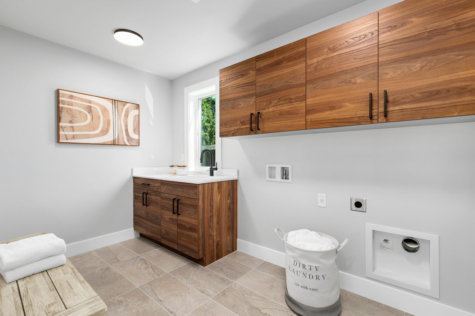 A spacious laundry room with custom cabinetry