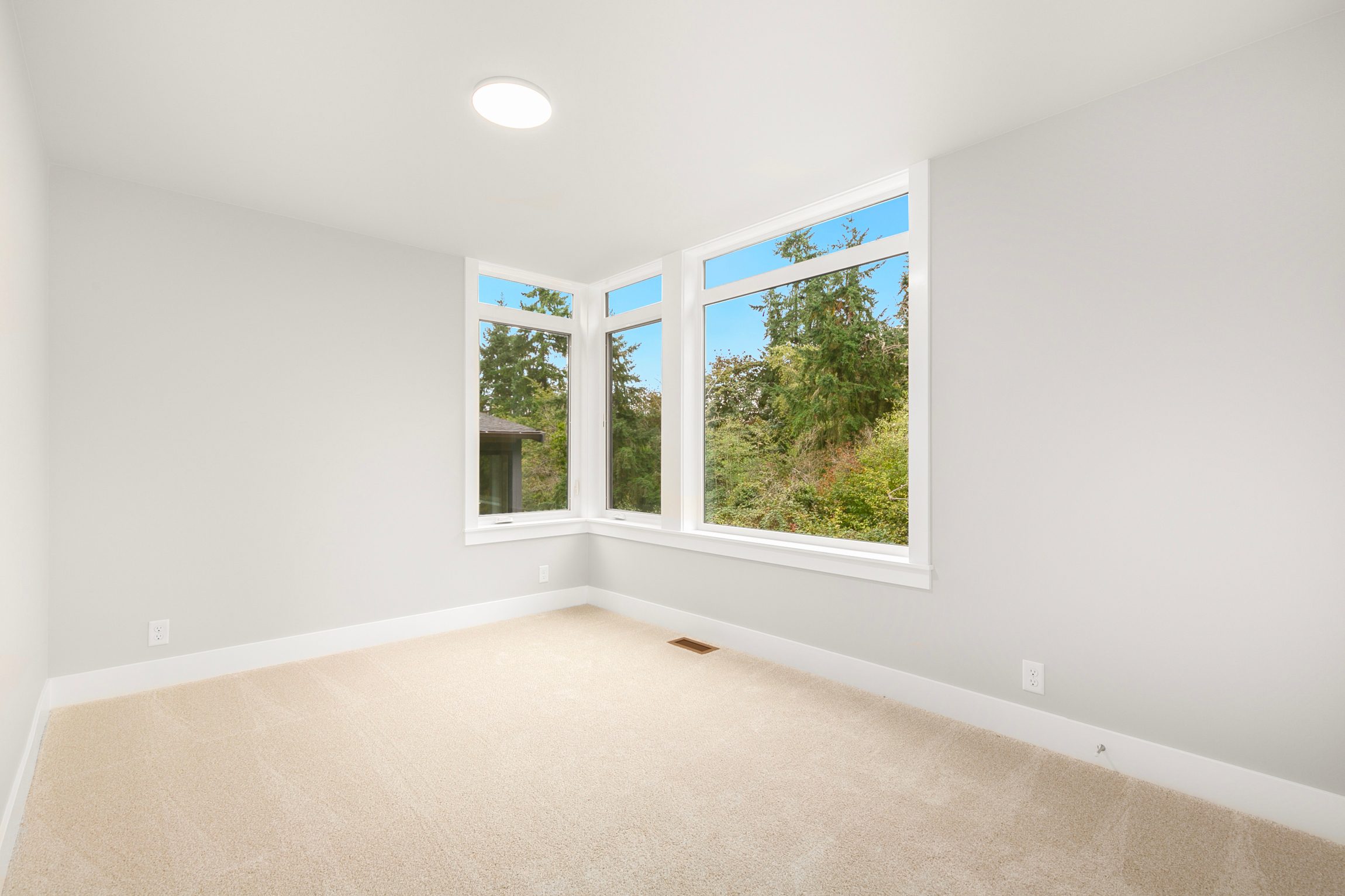 Secondary bedroom with large corner windows