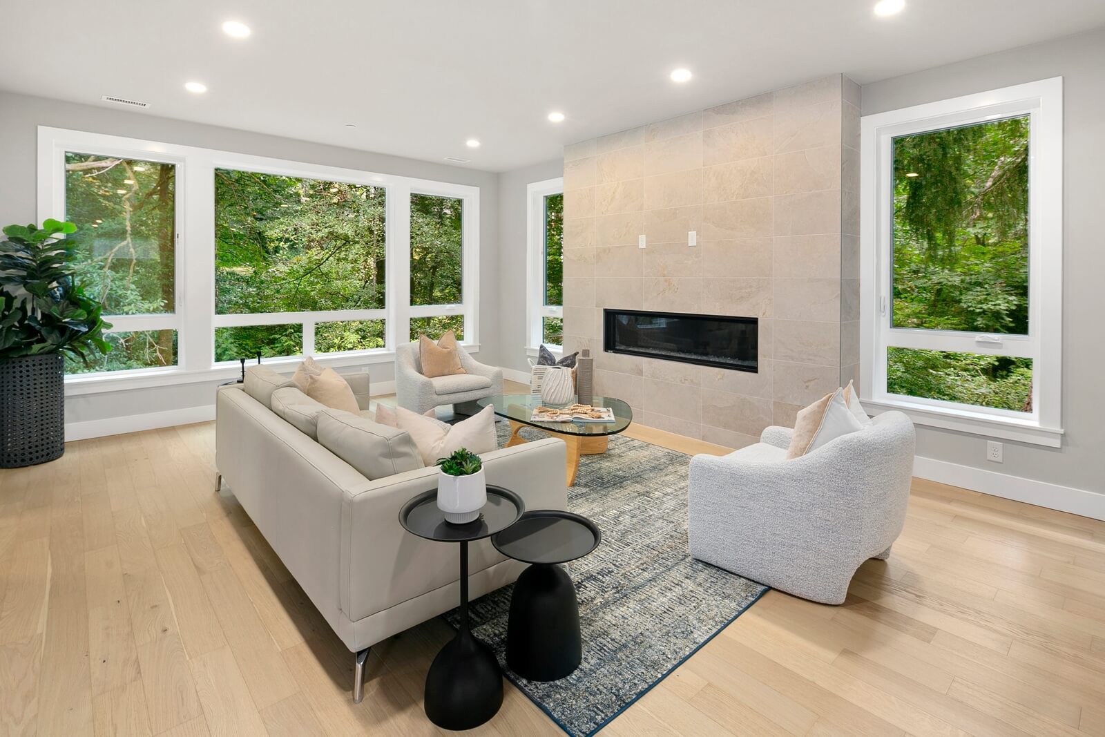 Open great room featuring a sleek fireplace