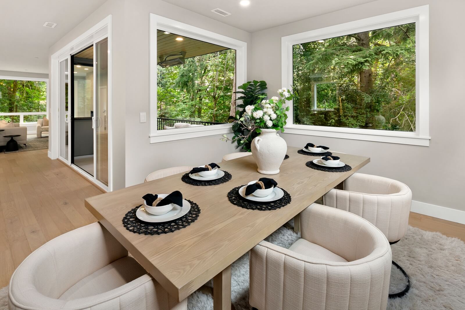 Expansive windows frame lush greenery backdrop