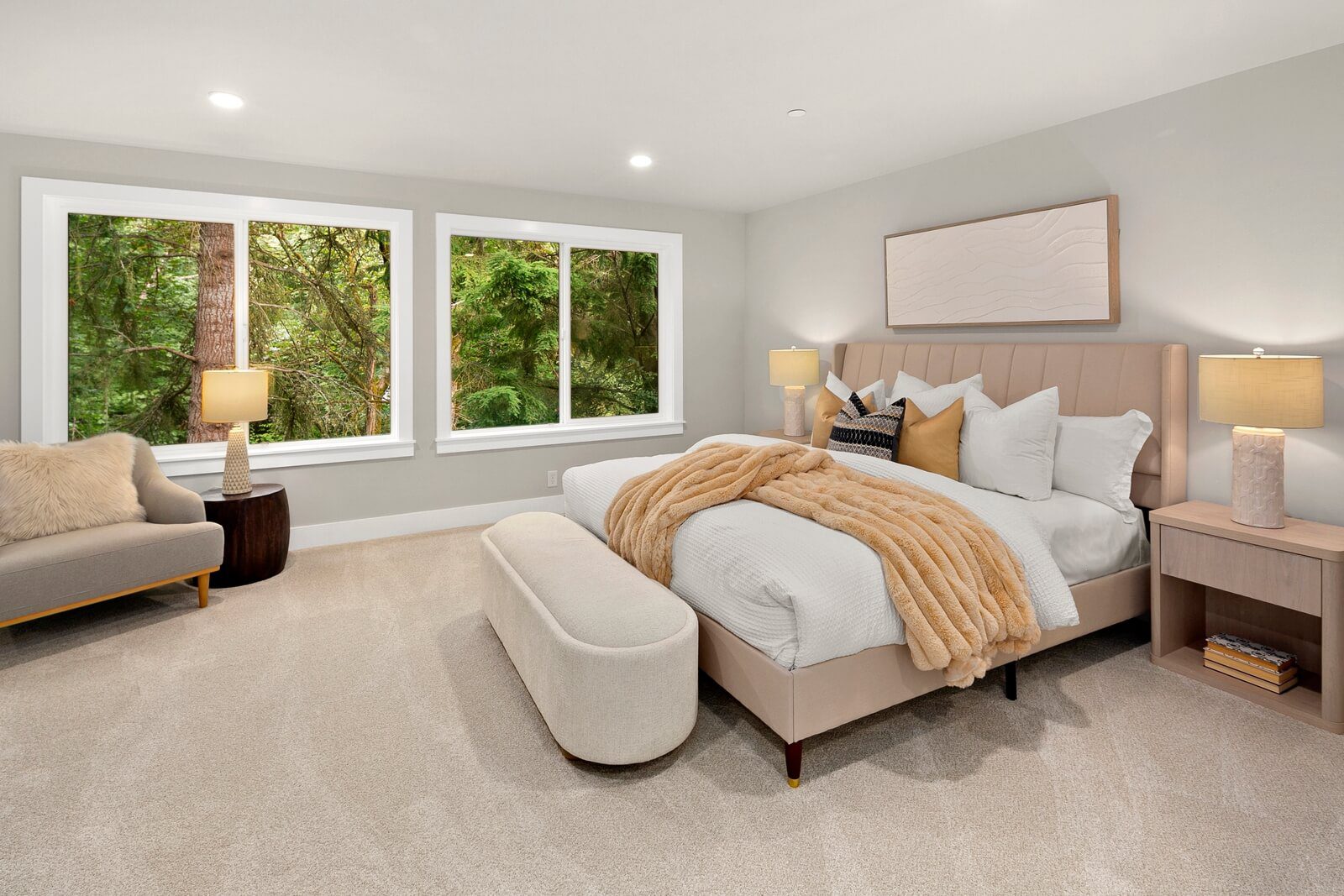 Spacious primary suite surrounded by serene wooded views