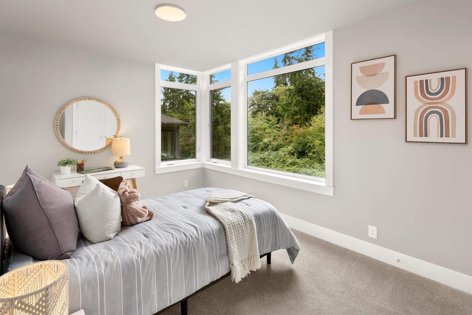 Light-filled bedroom with oversized windows and peaceful views