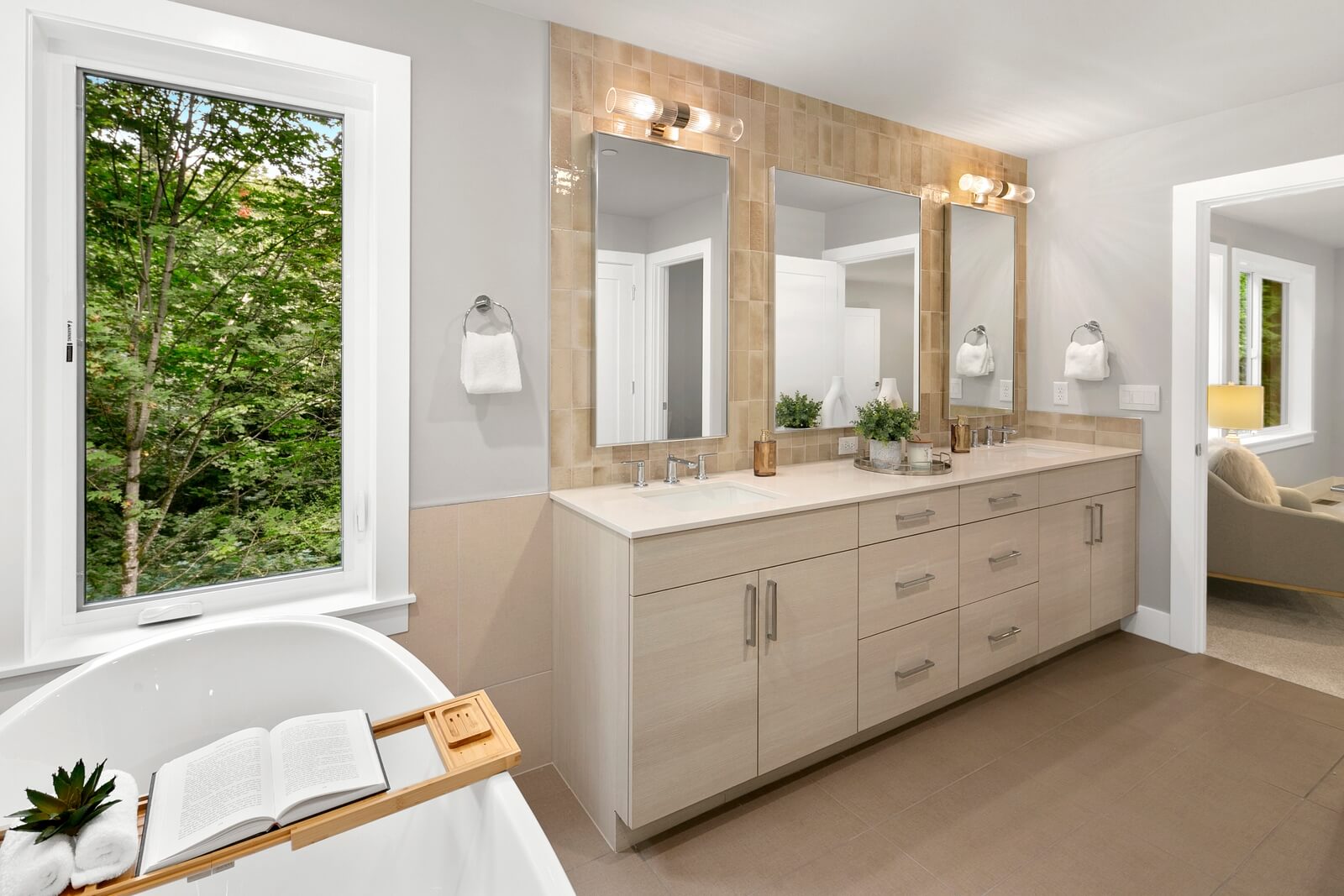 Spacious dual vanity with warm tile accents and abundant storage