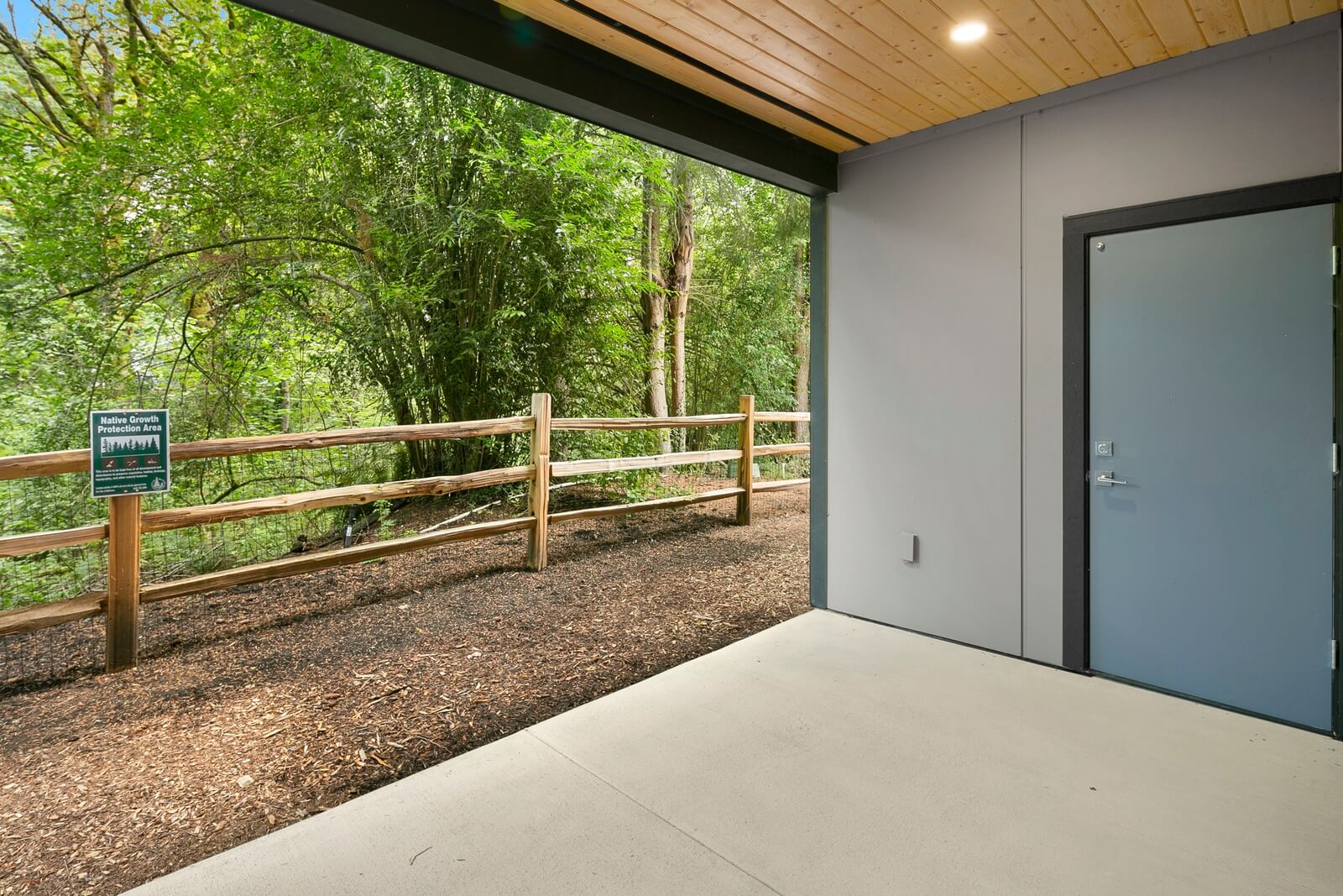 Covered outdoor space opening to a peaceful natural setting