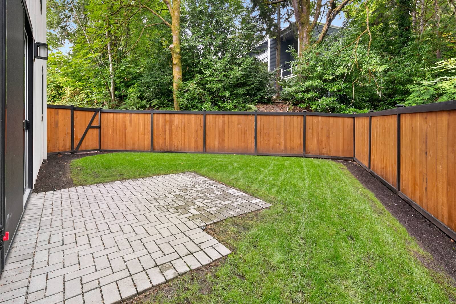 Private fenced backyard with patio and lawn space