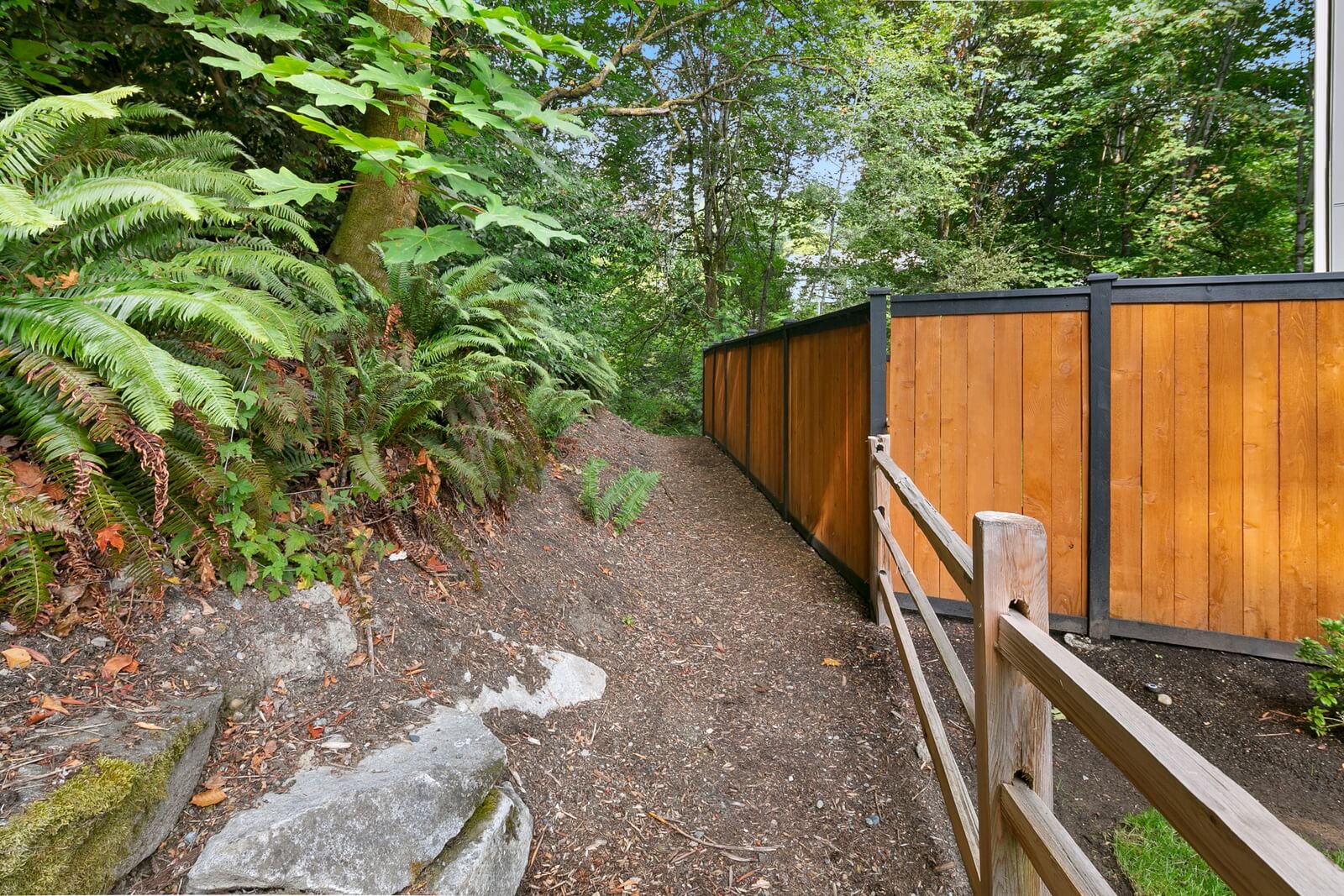 Wooded private trail alongside the home